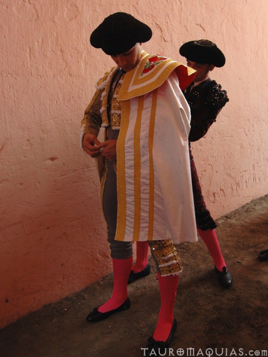 a man and a woman in costumes are looking at soing on the ground