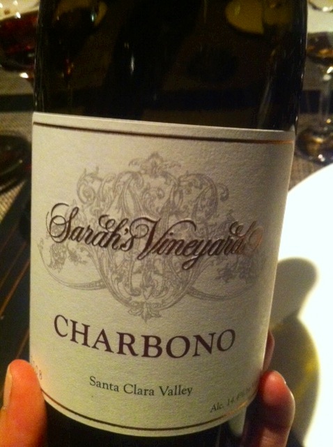 a bottle of chardonne in front of some wine glasses