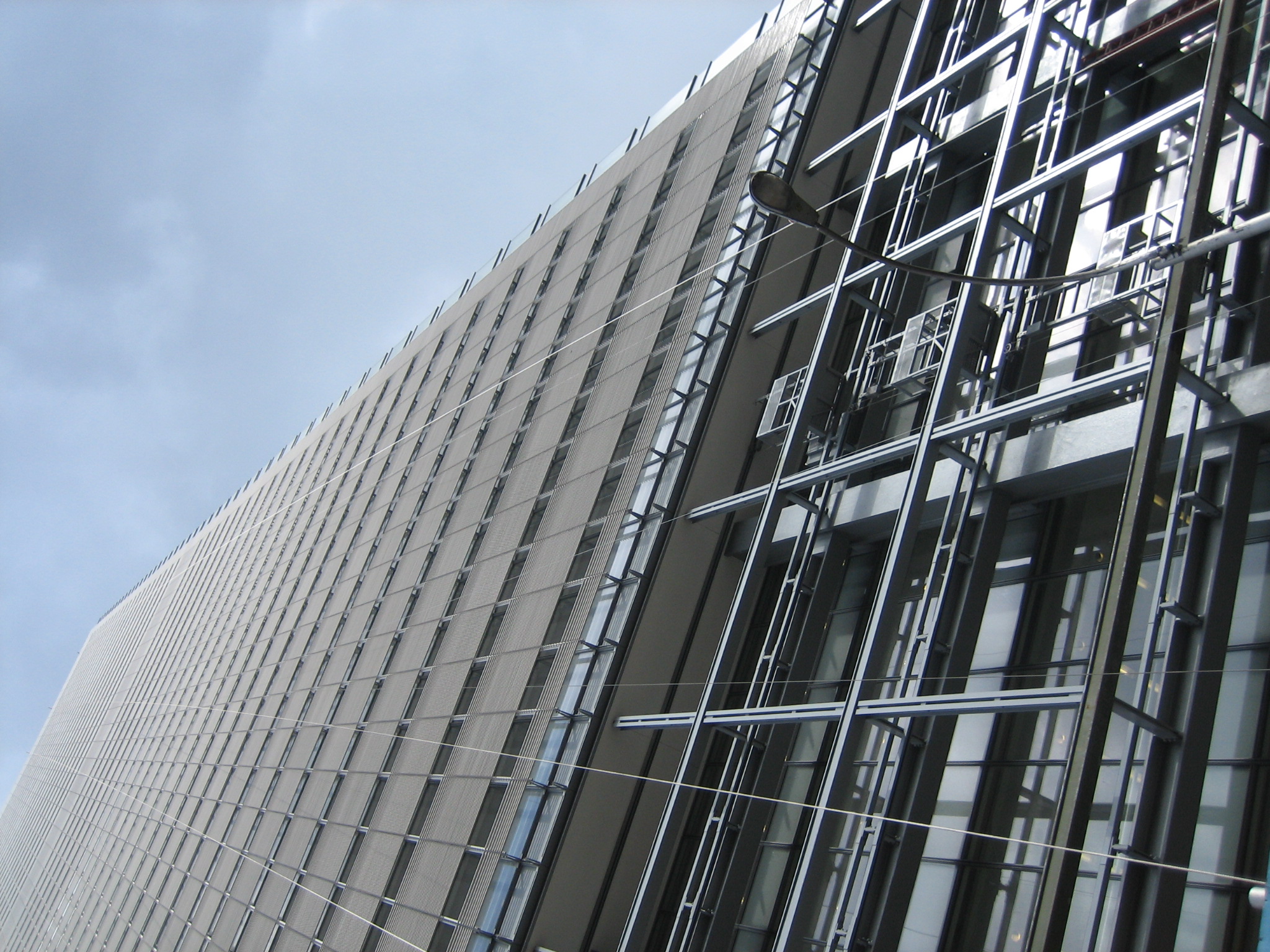 view looking up at a modern building with lots of windows