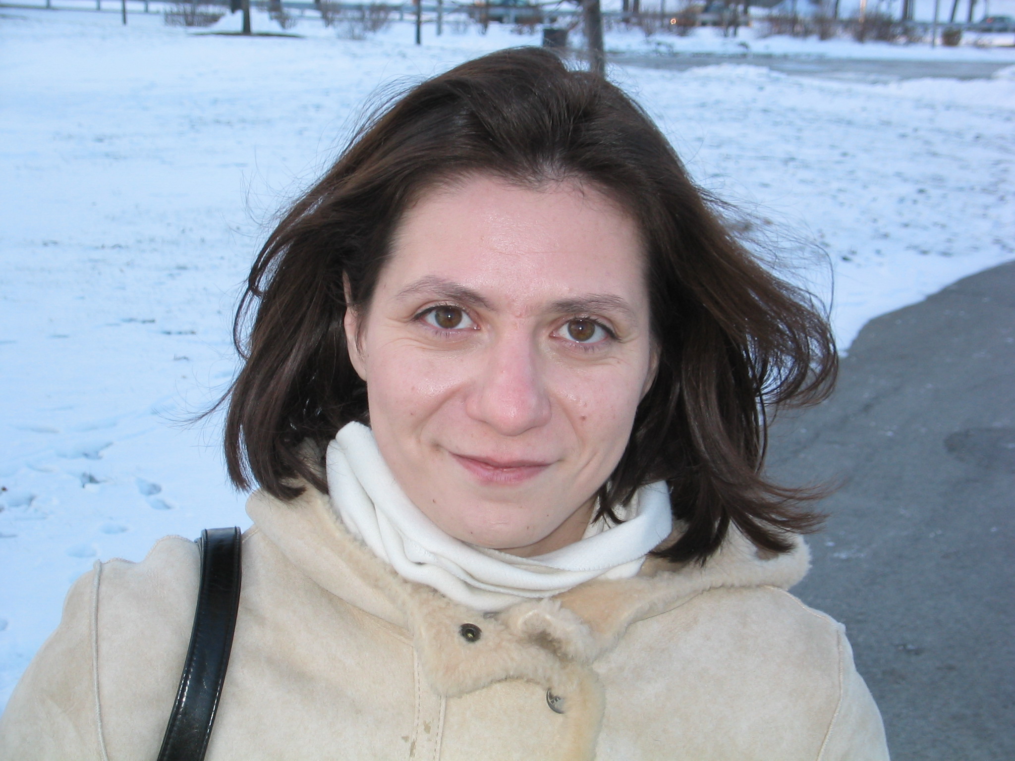 woman with large hair posing on snow covered field