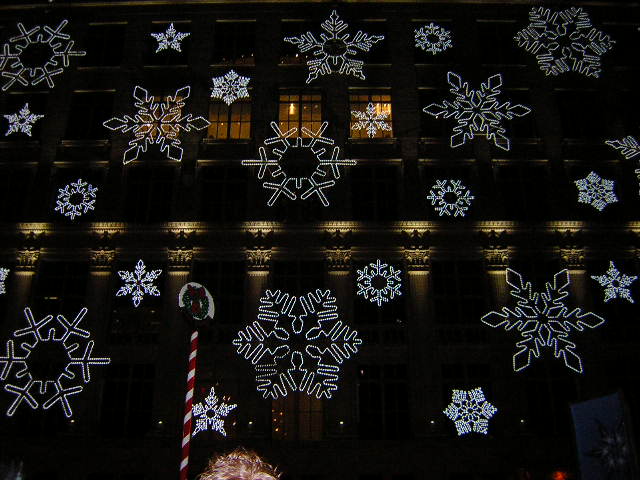 a building with lights and snowflakes all over it