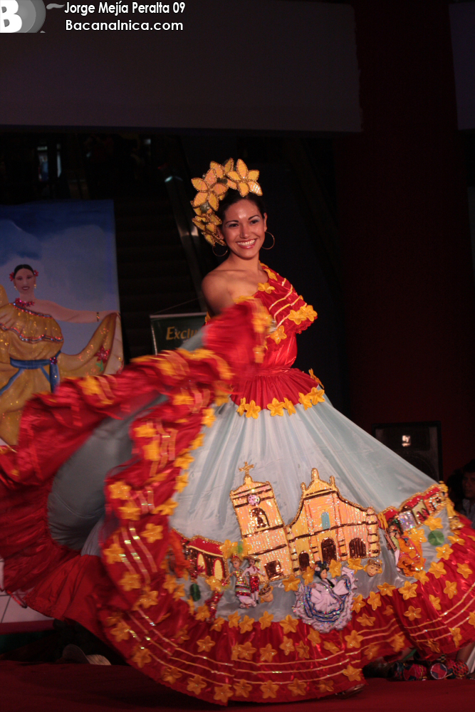 a woman with bright dress walking on the runway