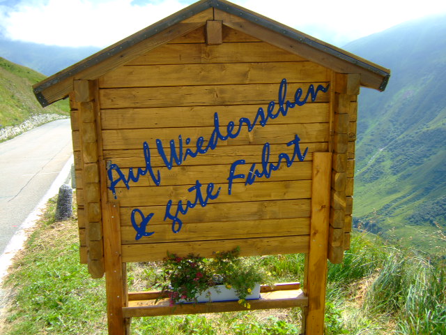a wooden building with the words back into nature written on it