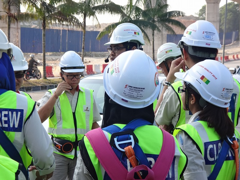 workers in hard hats on a construction site talking