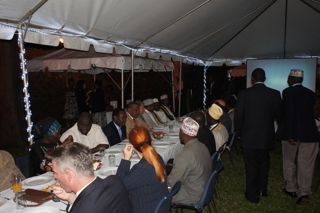 a large group of people are sitting in chairs under a tent