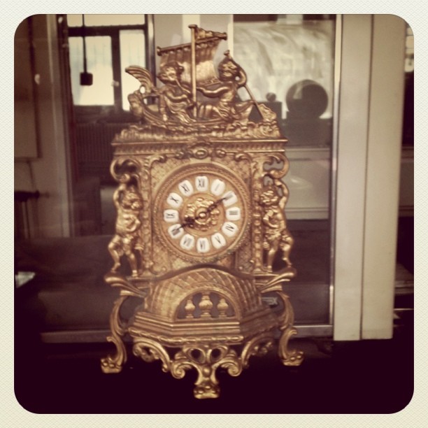 a large ornate clock sitting on top of a counter