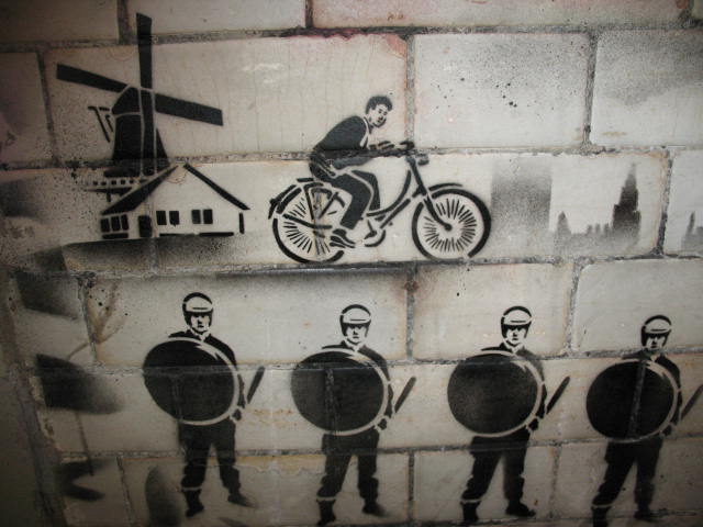 a person riding a bike is depicted on a wall