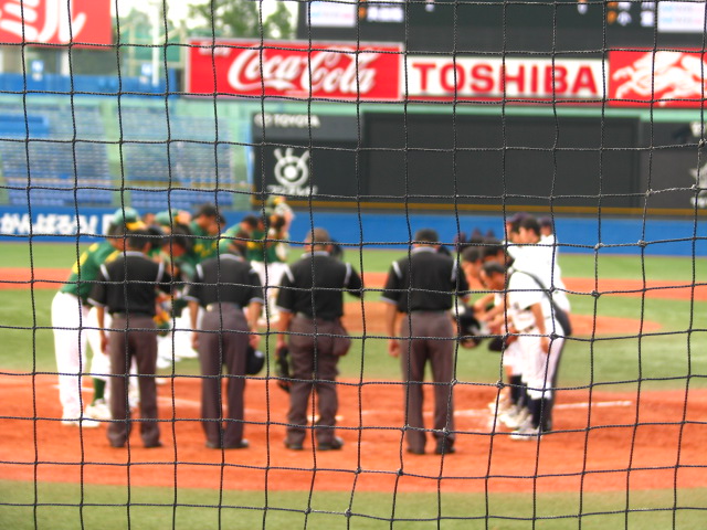 the pitcher is talking to a small crowd