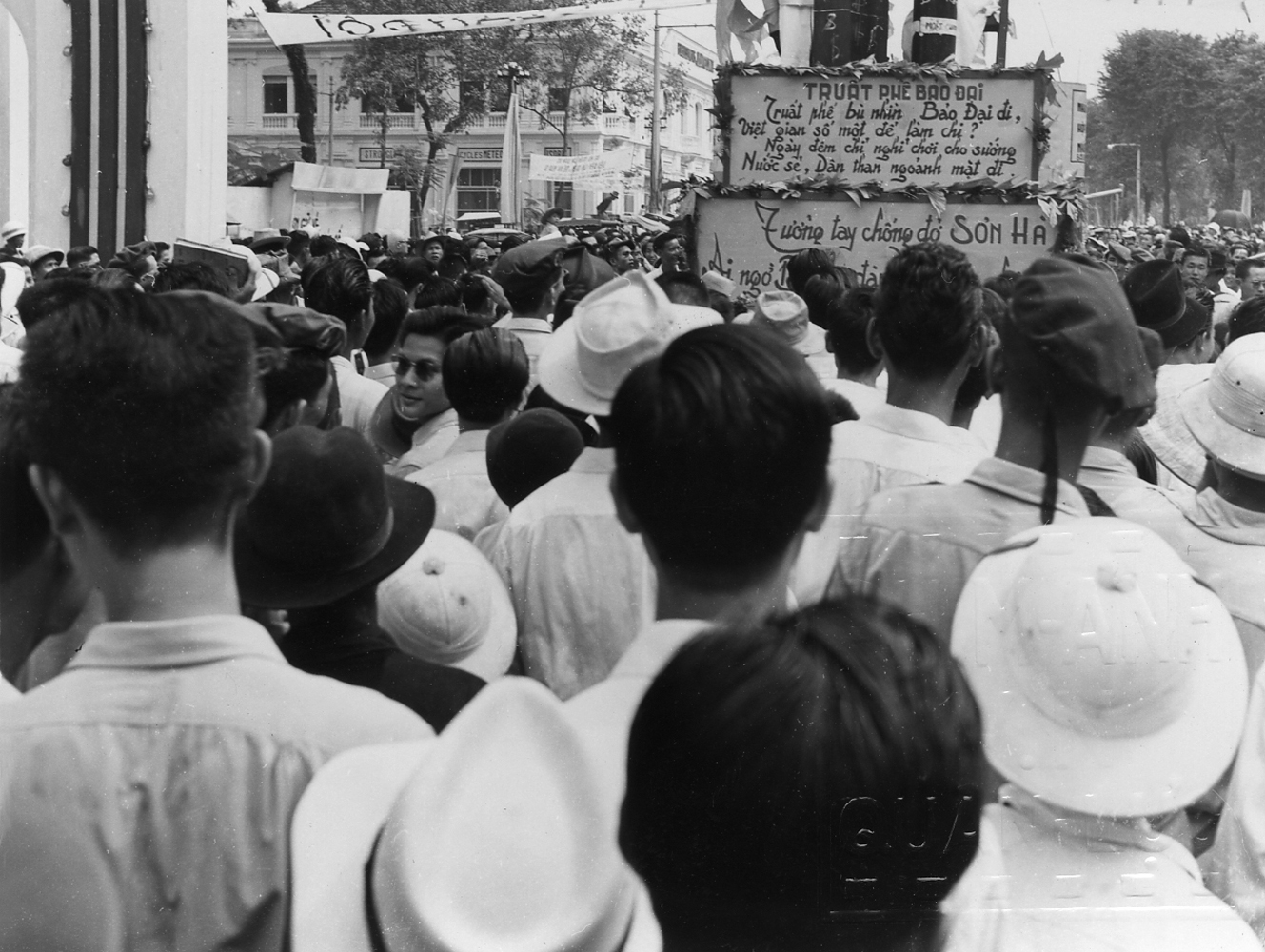 large crowds of people are gathered to listen to a speaker