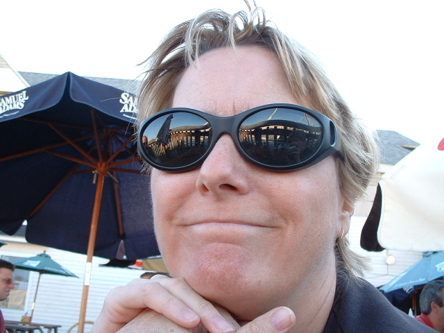 a woman wearing sun glasses on top of her eyes