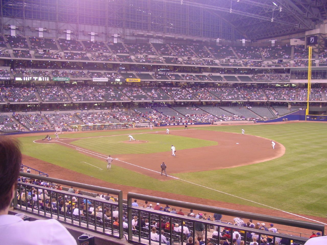 an arena in front of a group of people watching a baseball game