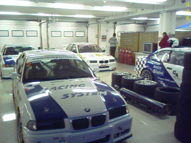 there are many race cars parked inside a garage