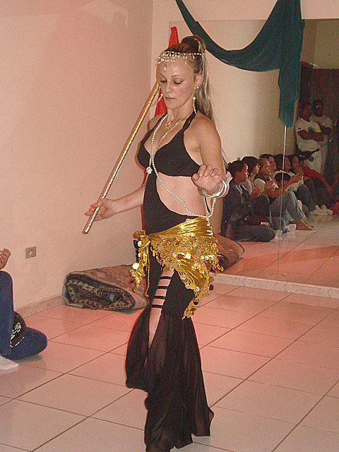 a woman in an outfit holding a bamboo stick