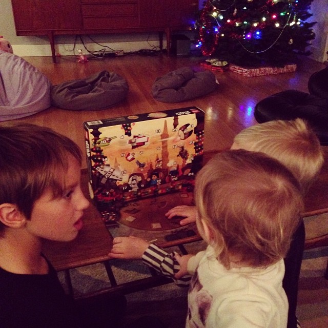 a little girl playing a game with her younger brother
