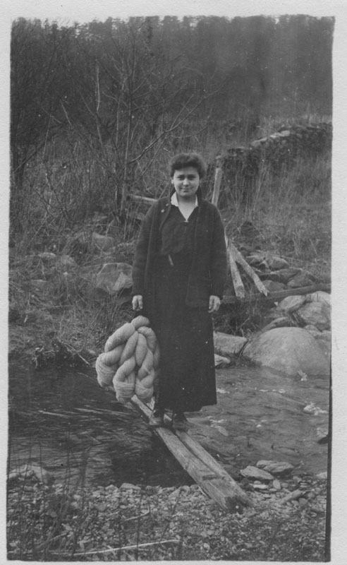 an old po of a woman on a log with some water