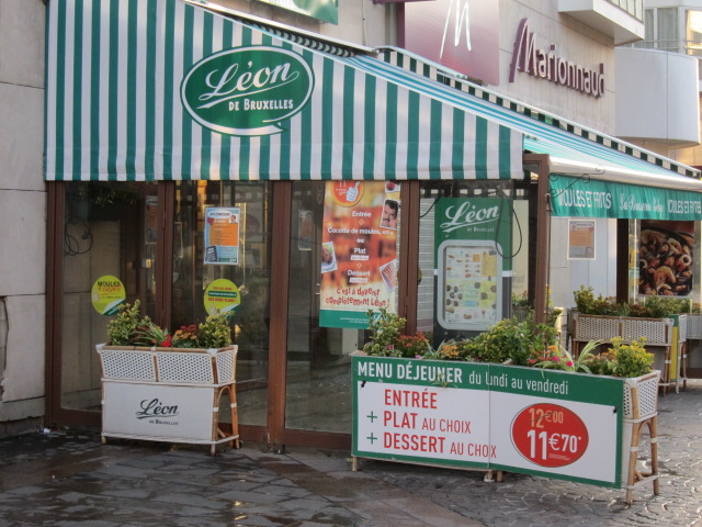 a storefront on a street corner with a sign for the planters