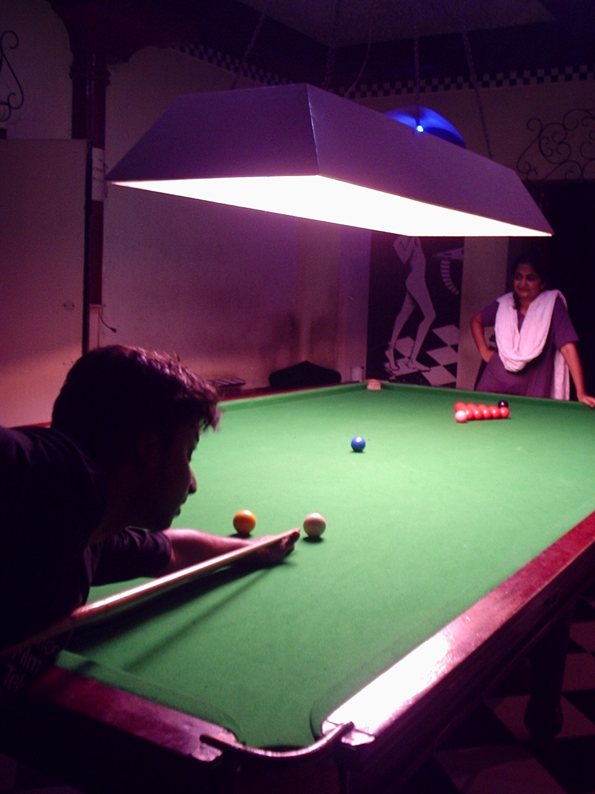 two people playing pool at the same time