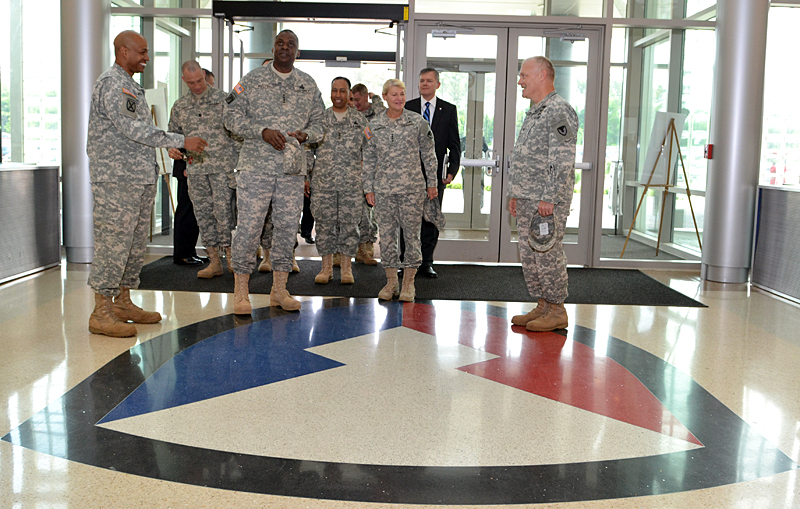 some military men standing near a doorway in the middle of a room