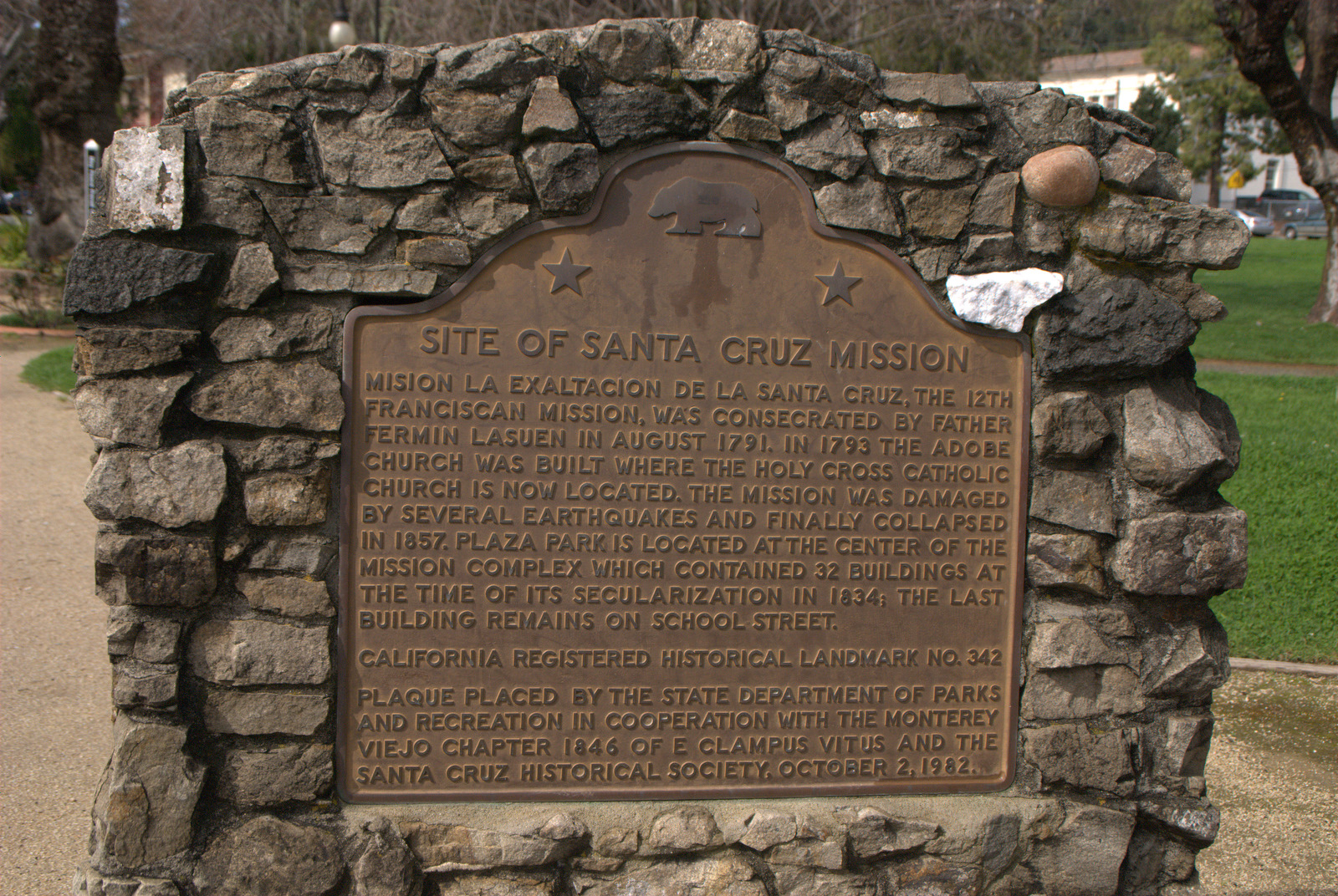 a large plaque in front of a stone wall