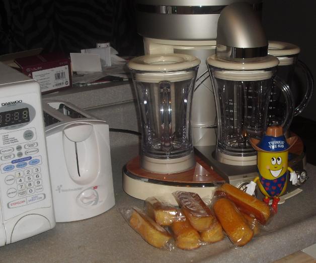 a counter with various electric appliances and a blender