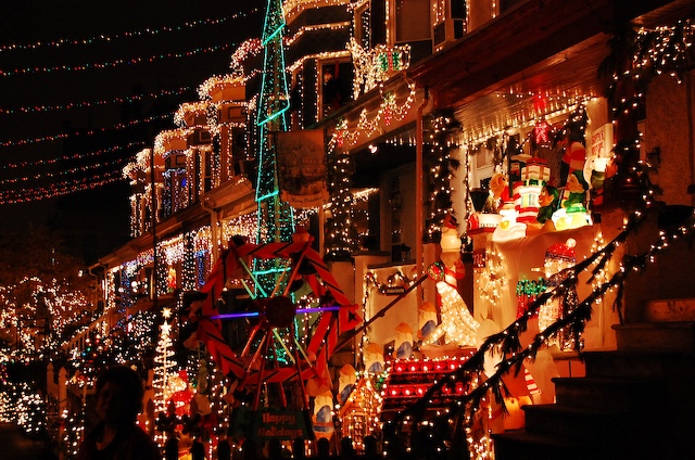the christmas lights on a street have been decorated with festive garlands