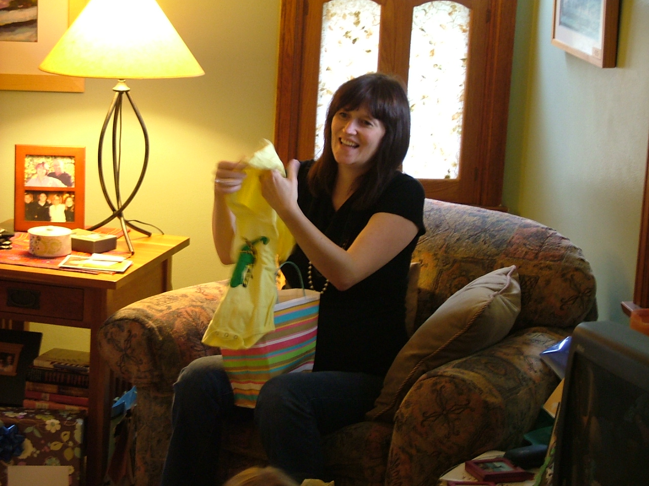 a woman that is sitting in a chair holding a bag