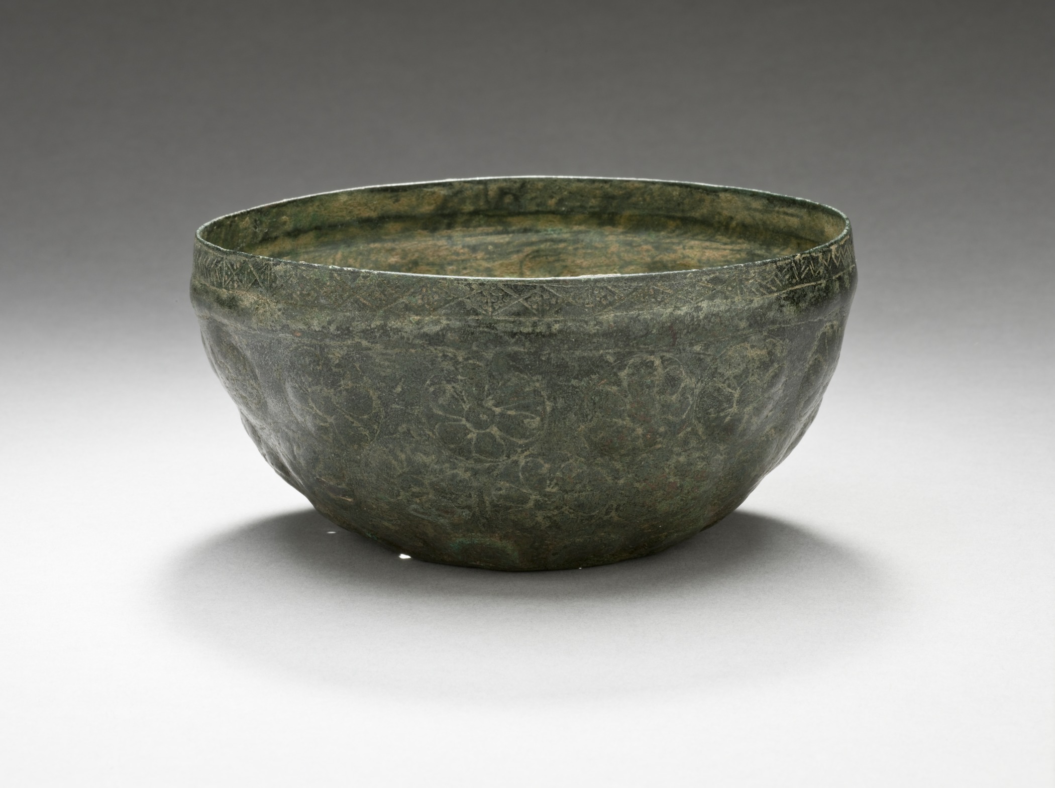 a green bowl is sitting on the table