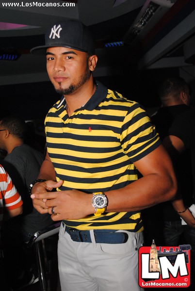 man with a yellow and black shirt and a watch