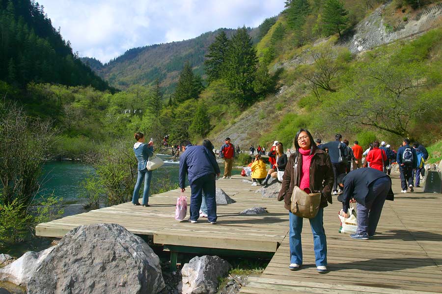 a group of people on the side of a bridge