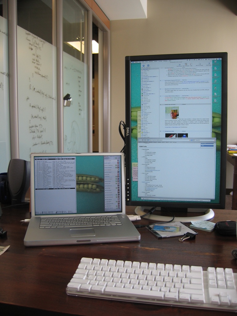 two computers that are side by side on a desk