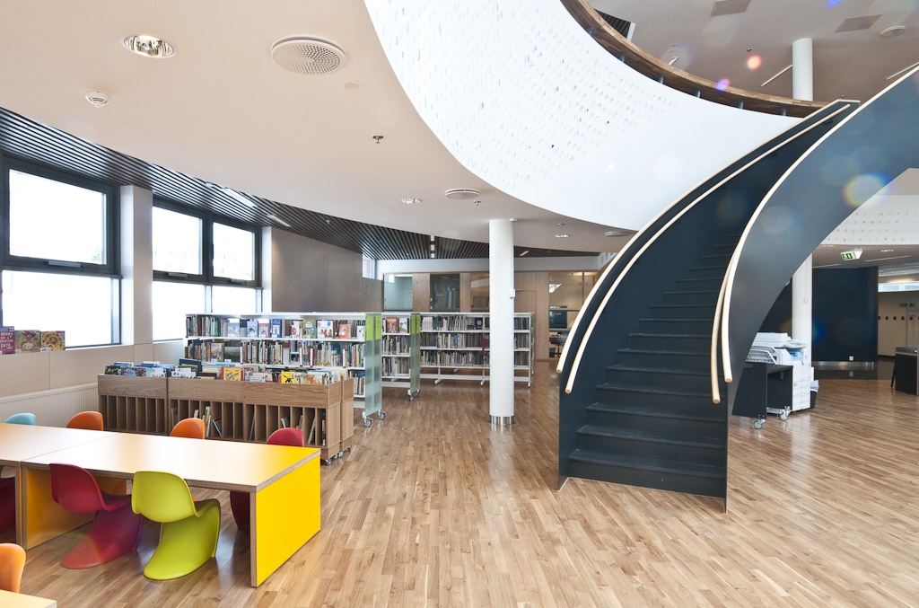 an open book store with stairs and colorful chairs