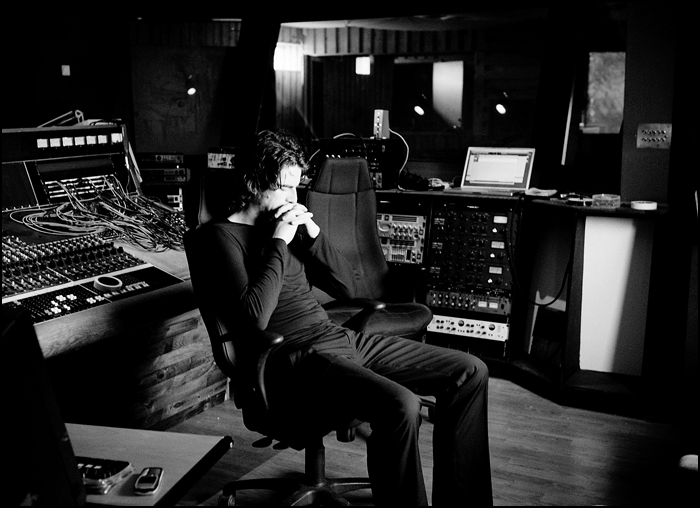 a man sitting in a chair in front of a control panel