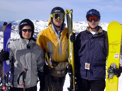 a group of people standing on top of a ski slope