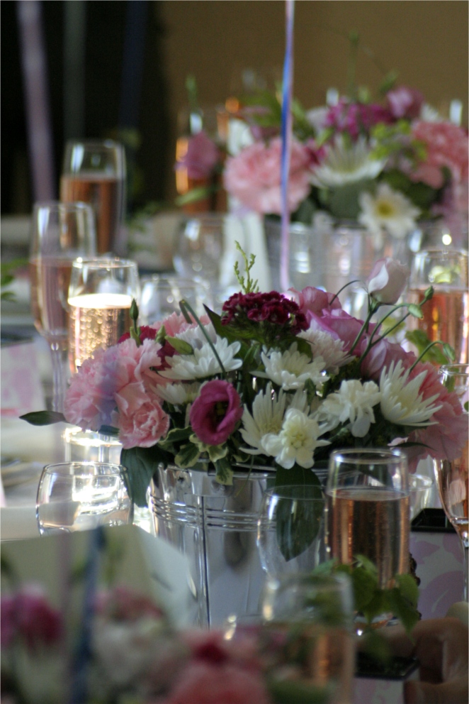 flowers and candles are lined up for an elegant dinner