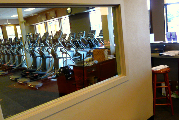 a row of machines are seen from the mirror in the lobby of a business