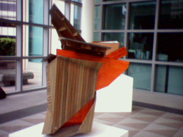 a sculpture made of books in front of a building