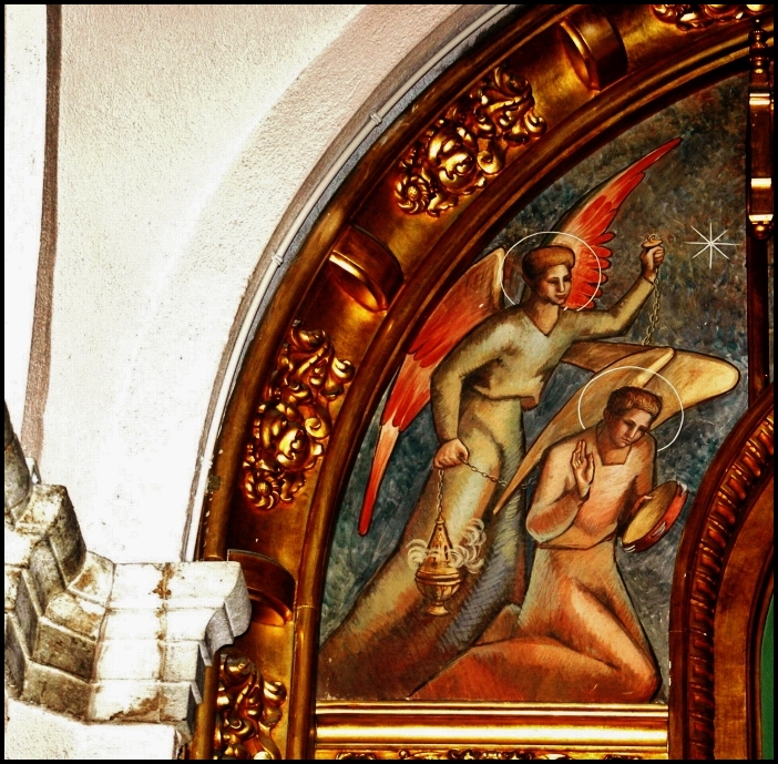 a picture of a painted religious object above some statues