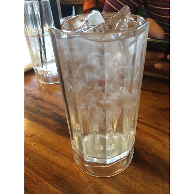 two glasses filled with ice, water, and water cubes