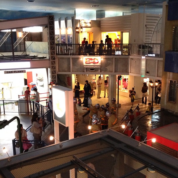 an image of people walking down the street inside the mall