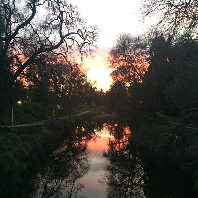 sunset along a river, reflecting the sky