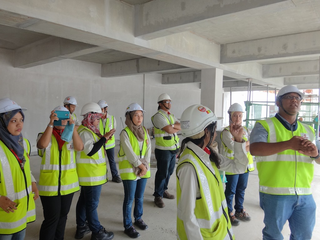 some construction workers are holding their hands up in the air