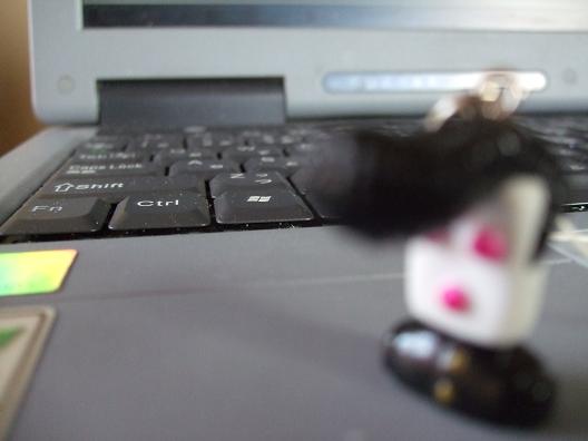 a small toy is on top of a computer keyboard