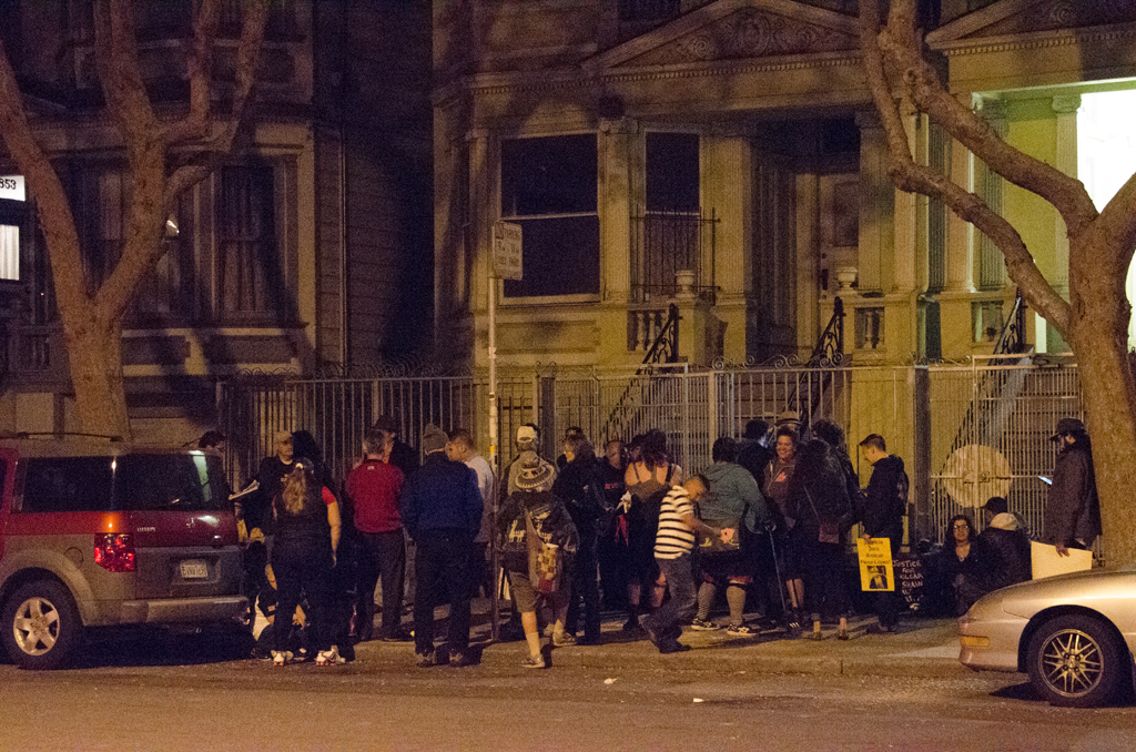 a crowd is gathered around a fenced in area