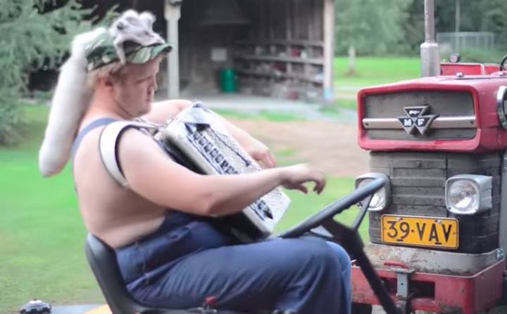 there is a man sitting on the back of a tractor