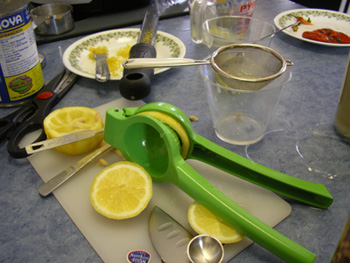 a table with limes, lemons, and other items for making orangeade