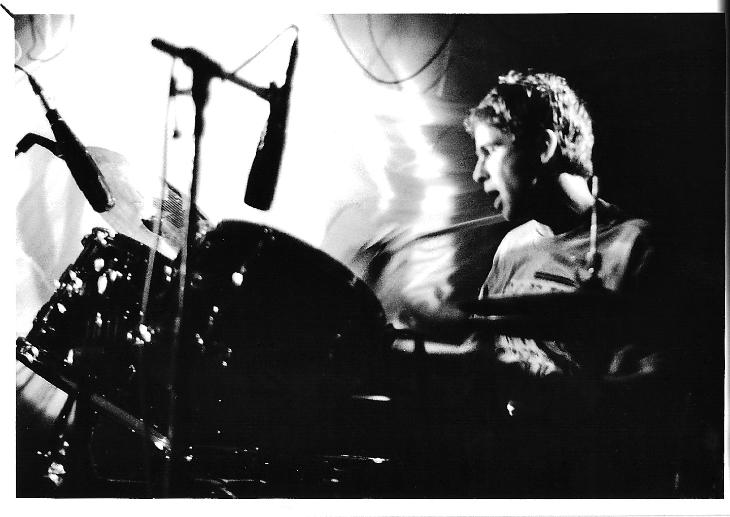 a man playing drums in a music band
