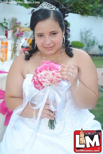 a woman that is standing near a bunch of flowers