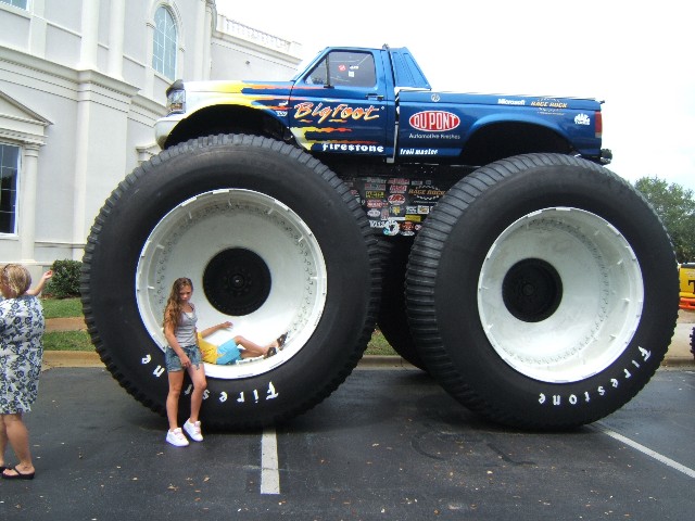 a monster truck with two tires attached to the front of it