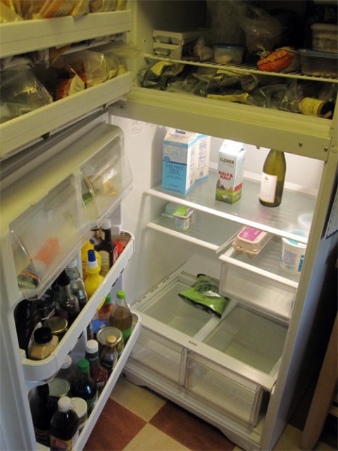a refrigerator that is open with food and beverages