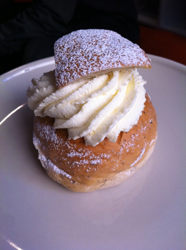 there is a powdered sugar topped donut with cream on it